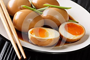NitamagoÃÂ is a boiledÃÂ eggÃÂ in savory sauce close-up in a plate. horizontal photo